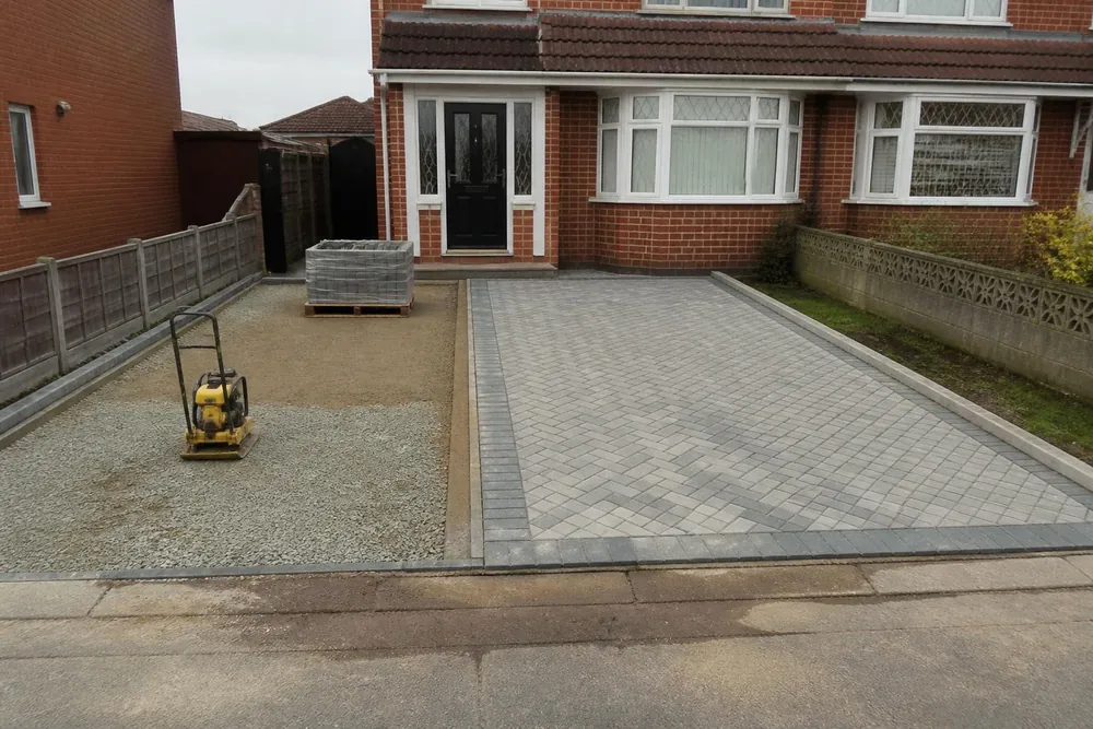 Block paving part-laid on a screeded sand bed over a compacted stone sub-base